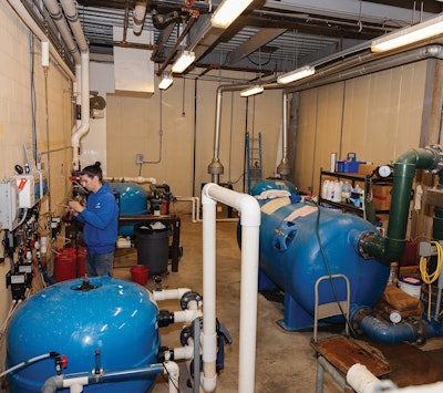 Patriot Water Works Lead Water Management Technician Tyler Boyde tests water and verifies chemical controller reading accuracy.