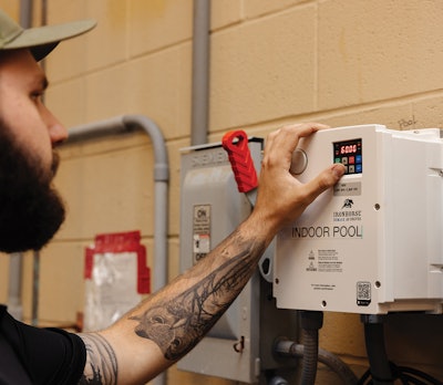 Patriot Water Works Install Technician Thomas Soukup starts a filter pump VFD.