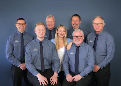 From left to right: Evan Baard, Connor Gibbs, John Kenyon, Caley Gibbs, Jason Dedels, Ed Gibbs (CEO) and Peter Friis (COO). The five at left have all earned their Master CBP.