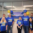 Team in blue shirts celebrating Xtreme Days of Customer Appreciation event