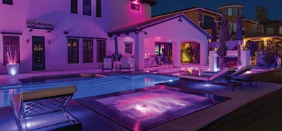 The polished jewel at night. Nearly 1,000 feet of conduit was installed to support multiple lighting zones around the various seating areas and recessed steps. Some of these zones are controlled through timers and automation tied to the pool equipment, while others are integrated into the home's lighting system.