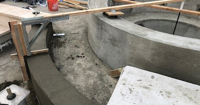 Three custom jigs, each using the center point and a fixed revolving radius, helped create this circular tiled spa.