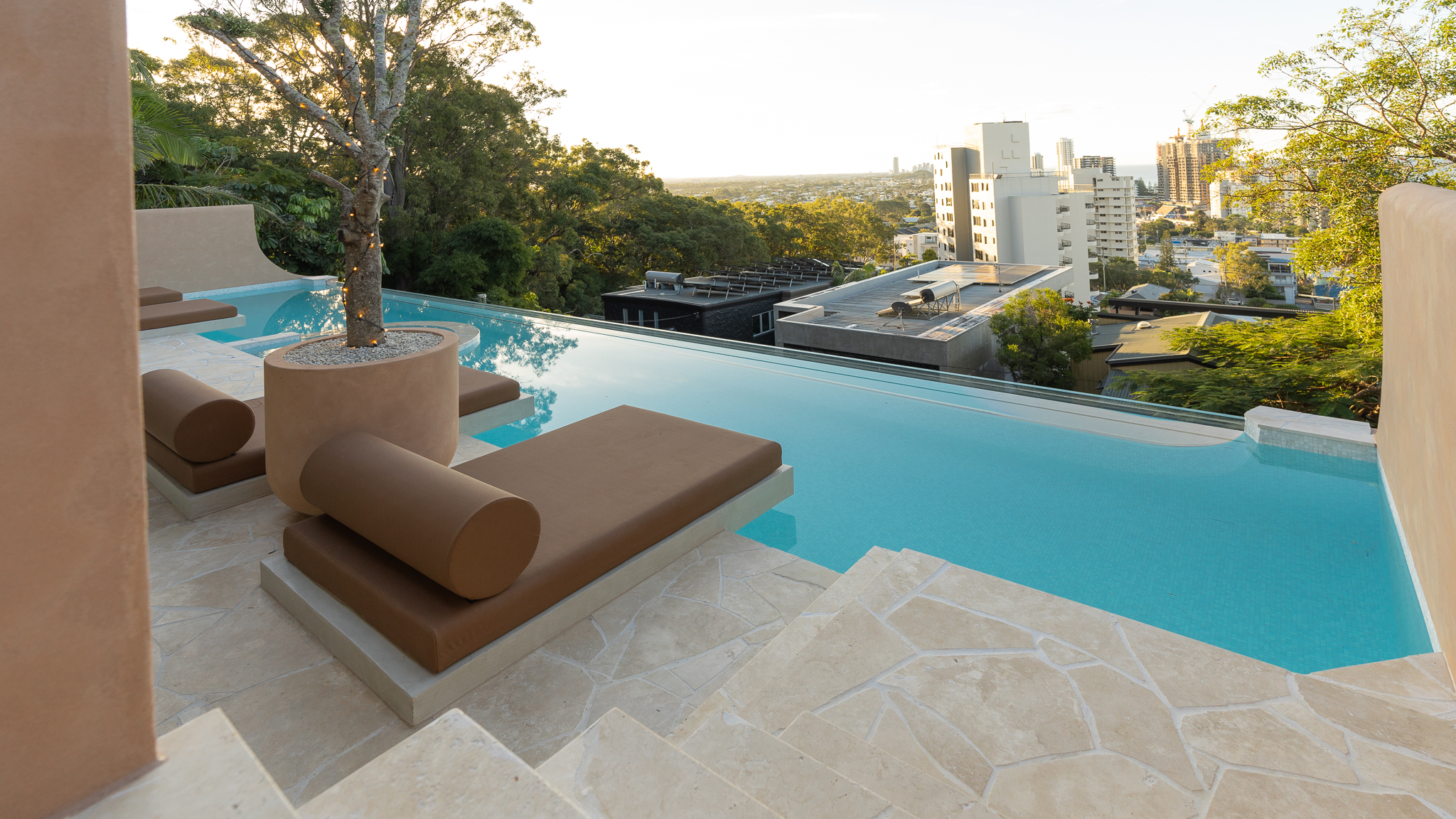 Infinity pool overlooking urban landscape with modern minimalist design