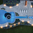 Aerial night view of guitar-shaped swimming pool with landscape lighting