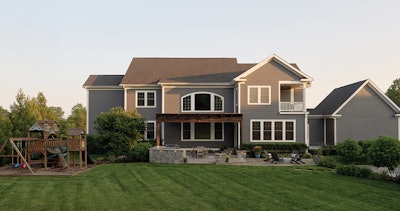 Phase one, shown here, connects seamlessly to the home: a dining terrace and outdoor kitchen under a pergola, designed for everyday family life.