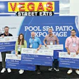 Six people posing with oversized checks at Pool Spa Patio Expo event