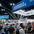 Trade show floor with attendees exploring technology and business exhibits