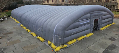 Temporary enclosures create a controlled environment for cold-weather pool construction.