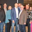 Group of professionals posing together at an indoor corporate event