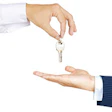 Business hand passing silver key between white and blue sleeves