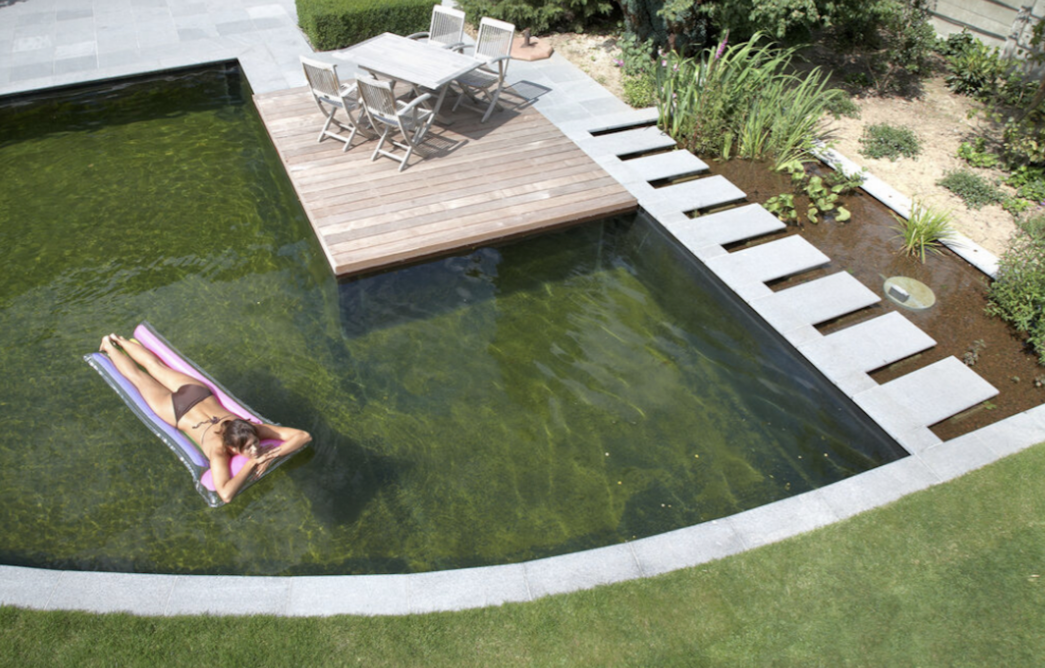 Courtesy Renolit Natural Swimming Pool With Person Floating