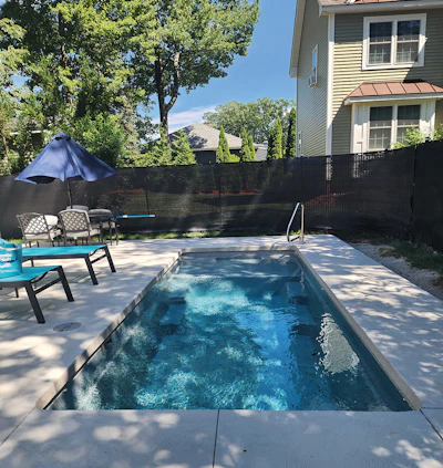 Snyder Pools built this small fiberglass vessel to neatly accommodate space constraints in a suburban Massachusetts home.