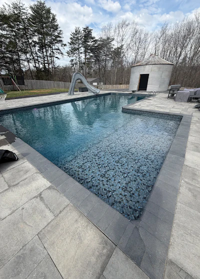 Vinyl pools provide amenities like this tanning ledge for customers looking for a higher-end pool without plaster surfaces.
