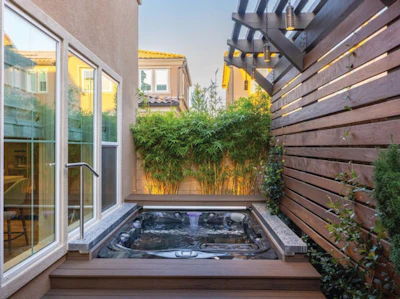 The home's walls and exterior fences can carve out a cozy, private space for an exceptional spa installation.