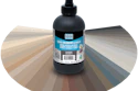Black grout colorant and sealer bottle with Laticrete label displayed against a color swatch fan showing neutral and gray tones