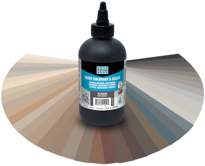 Black grout colorant and sealer bottle with Laticrete label displayed against a color swatch fan showing neutral and gray tones