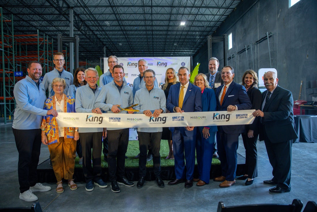 Group of business professionals at ribbon-cutting ceremony for King facility opening