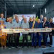 Group of business professionals at ribbon-cutting ceremony for King facility opening