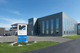Modern industrial building with Renolith company signage and blue logo sign in front
