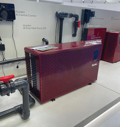 Red AI Pool Heat Pump X26 unit displayed in showroom with control systems and water treatment components