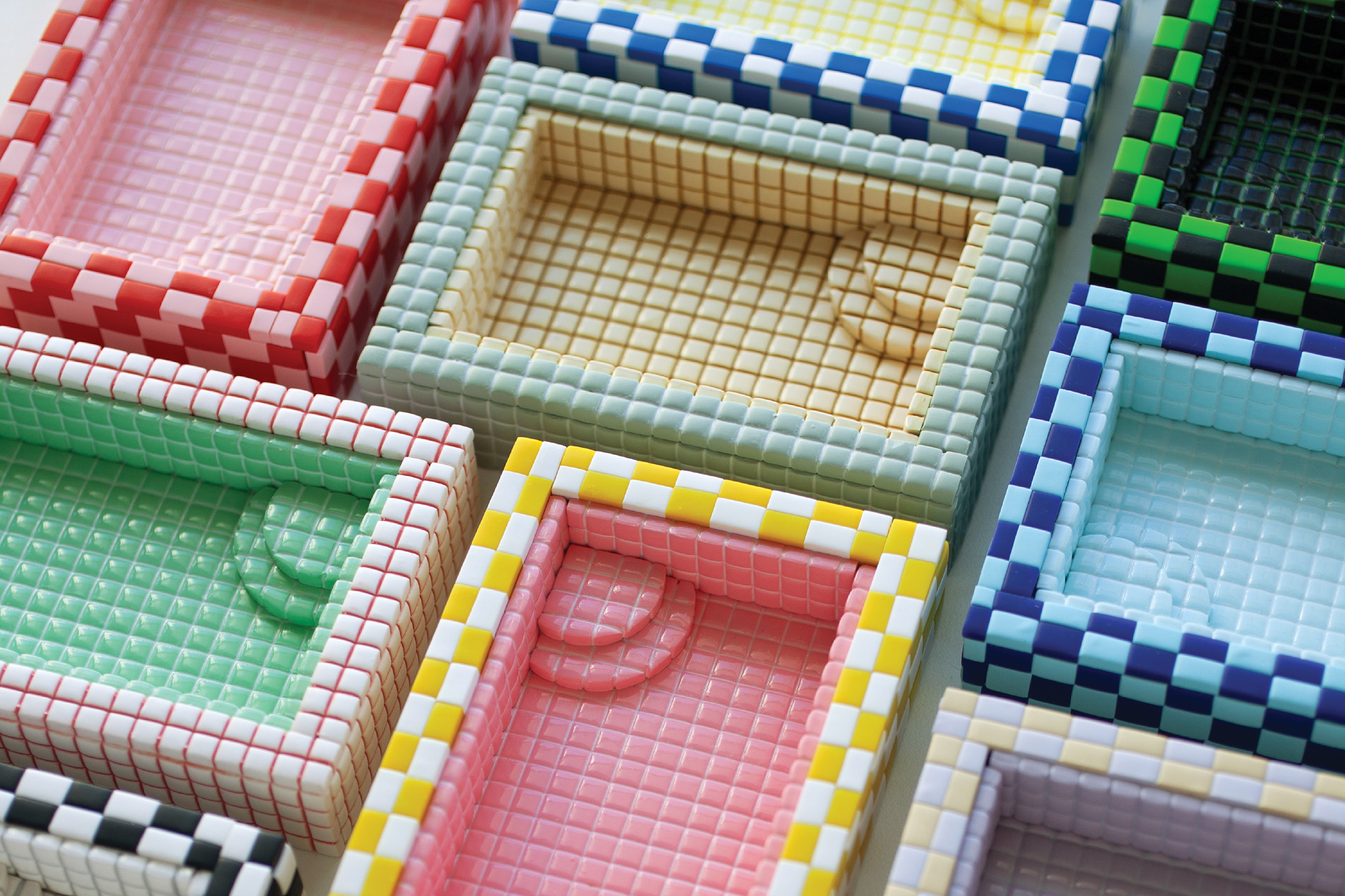 Colorful checkered fabric swatches arranged in compartments showing various color combinations and patterns