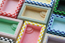 Colorful checkered fabric swatches arranged in compartments showing various color combinations and patterns