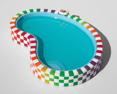 Colorful checkered inflatable swimming pool with turquoise water and rainbow striped rim