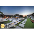 Luxury modern home with illuminated pool and manicured lawn at dusk, featuring HIA 2026 Gold Award of Excellence badge