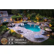 Luxury backyard pool with stone patio, ambient lighting, and 2026 Awards of Excellence merit badge
