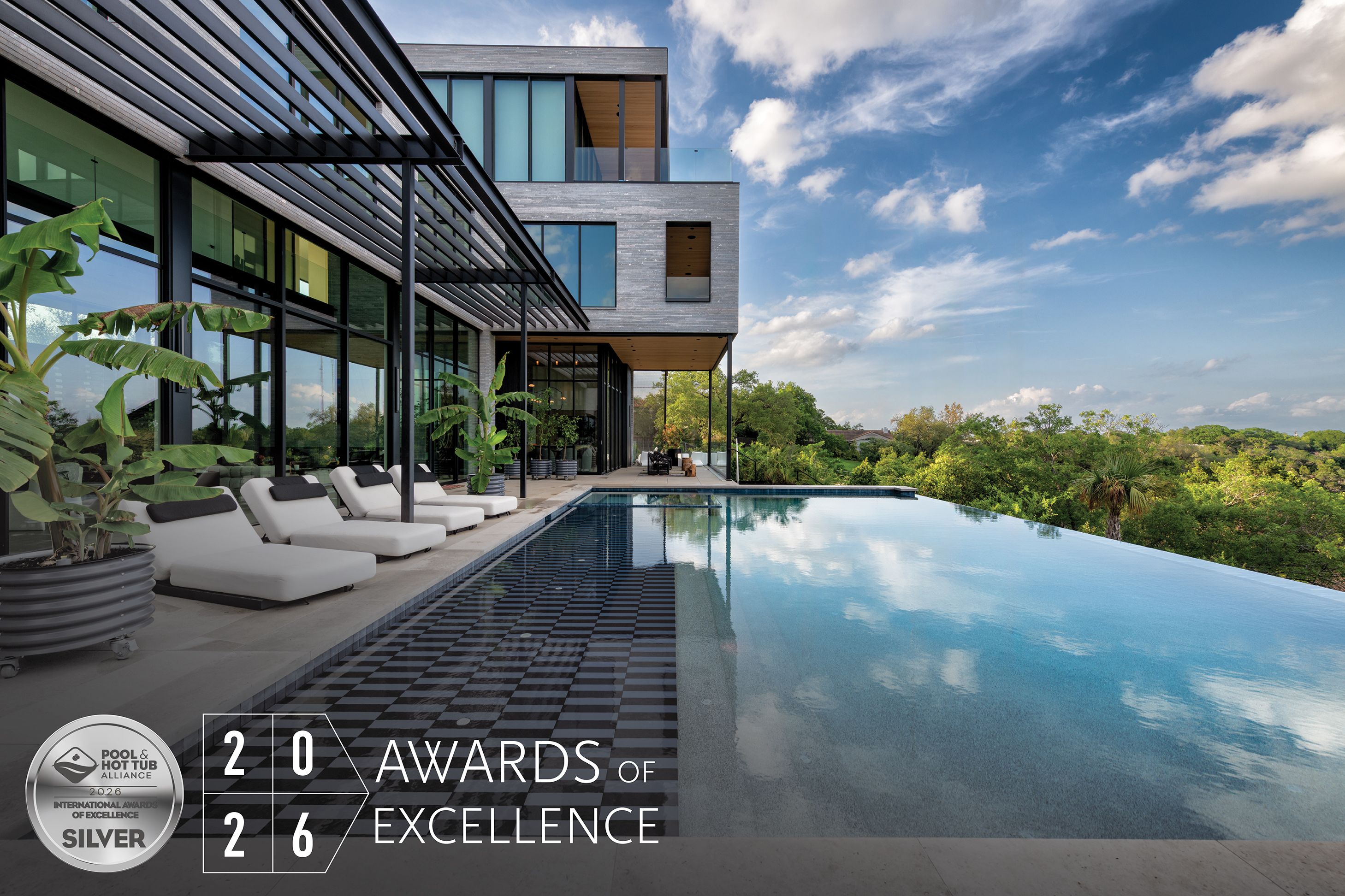 Modern luxury home with infinity pool overlooking landscape, featuring WAF 2026 Silver Award of Excellence certification