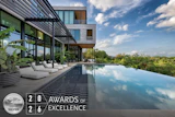 Modern luxury home with infinity pool overlooking landscape, featuring WAF 2026 Silver Award of Excellence certification