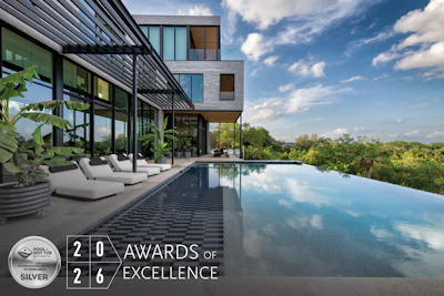Modern luxury home with infinity pool overlooking landscape, featuring WAF 2026 Silver Award of Excellence certification