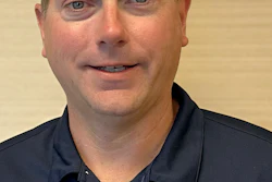 Professional headshot of a man wearing a navy Cover Care polo shirt against a neutral background